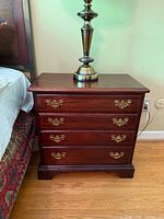 Front angled view showing overall design and one nightstand beside bed
