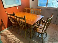 Dining table with five matching spindle-back chairs