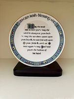 Front view of bone china plate on wooden stand showing full Irish Blessing text and Celtic border
