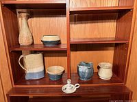 overview of all seven pottery pieces on shelving