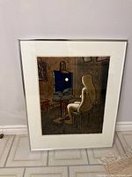 Framed lithograph full view leaning against wall