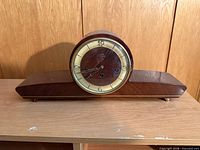 Front view of Solar mantle clock on shelf