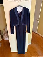 Full view of gown with bolero jacket on hanger