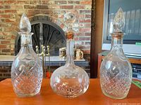 Front view of all three decanters showing shapes, cuts and stoppers