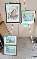 Front view showing all four framed artworks with size tags