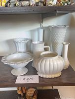 All seven milk glass pieces on shelf