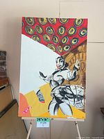 Front view of entire painting on easel showing artwork and size reference