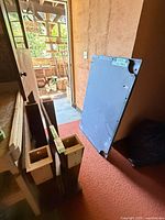 Slate bed piece leaning against wall near door
