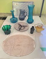 Group shot of nine handblown glass items on table