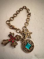 Full view of bracelet showing link chain and three charms