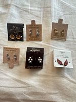 Overview of all six earring pairs on display cards