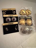 All six pairs displayed: three Lapor carded pairs left, three packaged pairs right