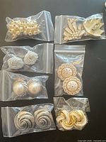 Overview of all seven earring pairs in individual bags