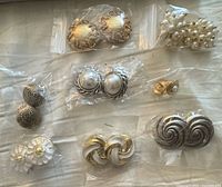 Group shot of all eight earring pairs in bags