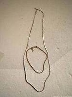 Necklace and bracelet laid out showing full length and design