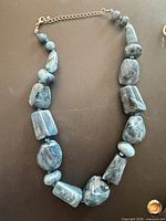 Full view of blue marbled acrylic bead necklace