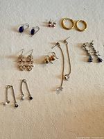 All eight pairs of earrings laid out