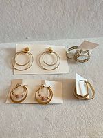 All four earring pairs laid out on white background