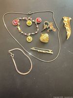 All seven jewelry items arranged on black background