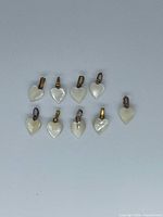 All nine mother-of-pearl heart pendants arranged