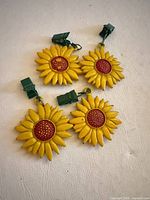 all four sunflower weights laid out showing clips and overall condition