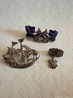 Overview of all three sterling silver brooches and pin