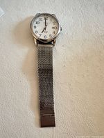Front view showing complete watch with mesh band extended