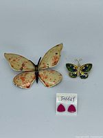 Group shot showing both butterfly brooches and pink stud earrings