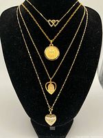 All four necklaces displayed layered on bust