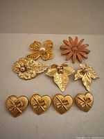Group shot of all nine brooches
