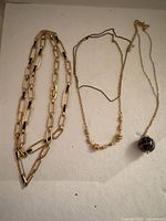 Overview of three necklaces laid out