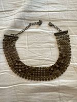 Full view of the collar necklace laid flat showing overall design
