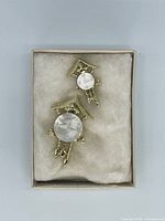 Two gold-tone cuckoo clock brooches in box