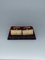 Front view of cufflinks in tray