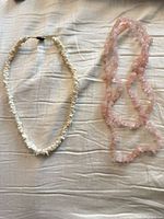 Full view of both necklaces laid flat
