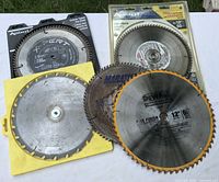 Group view of five circular saw blades showing brands, diameters and packaging