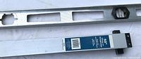 Straightedge showing blue product label and clamp mechanism