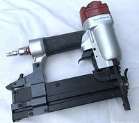 Left side view of Bynford Model 9040 nailer showing air fitting, grip and overall condition