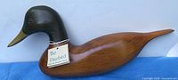 Full view of wooden duck decoy showing shape and finish