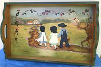Full view of painted wooden tray showing shape, handles, border and artwork