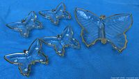 top view of all five butterfly dishes showing sizes and gold trim