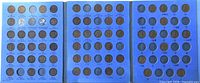 Open three-panel Whitman folder showing filled and vacant slots of Lincoln wheat cents