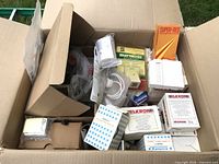 Overview of open carton with assorted boxed and loose security sensors