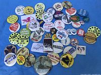 Full assortment of approximately 40 pinback buttons laid out in heart shape