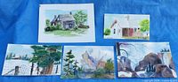 Five small watercolor paintings displayed
