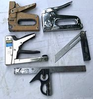 Staple guns, utility knife, combination square visible