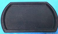 Top view of mottled brown Bakelite serving tray showing shape and raised rim