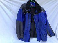Front view of blue and black Viking Tempest II jacket hanging