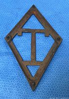 Front view showing full diamond shape, T-bar, and four studs
