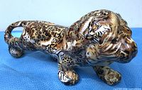 Left-side view of LaVie ceramic big-cat figurine showing leopard and zebra pattern